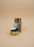 Two decorative containers with colorful labels on a marble surface. Two decorative containers with colorful labels on a marble surface.