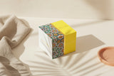Box with a colorful pattern on a beige surface Box with a colorful pattern on a beige surface
