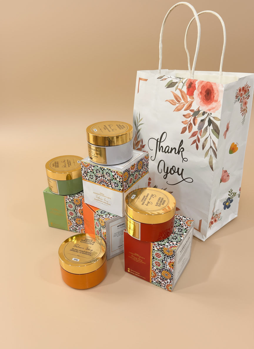 Gift set with jars and a floral-patterned bag on a beige background Gift set with jars and a floral-patterned bag on a beige background