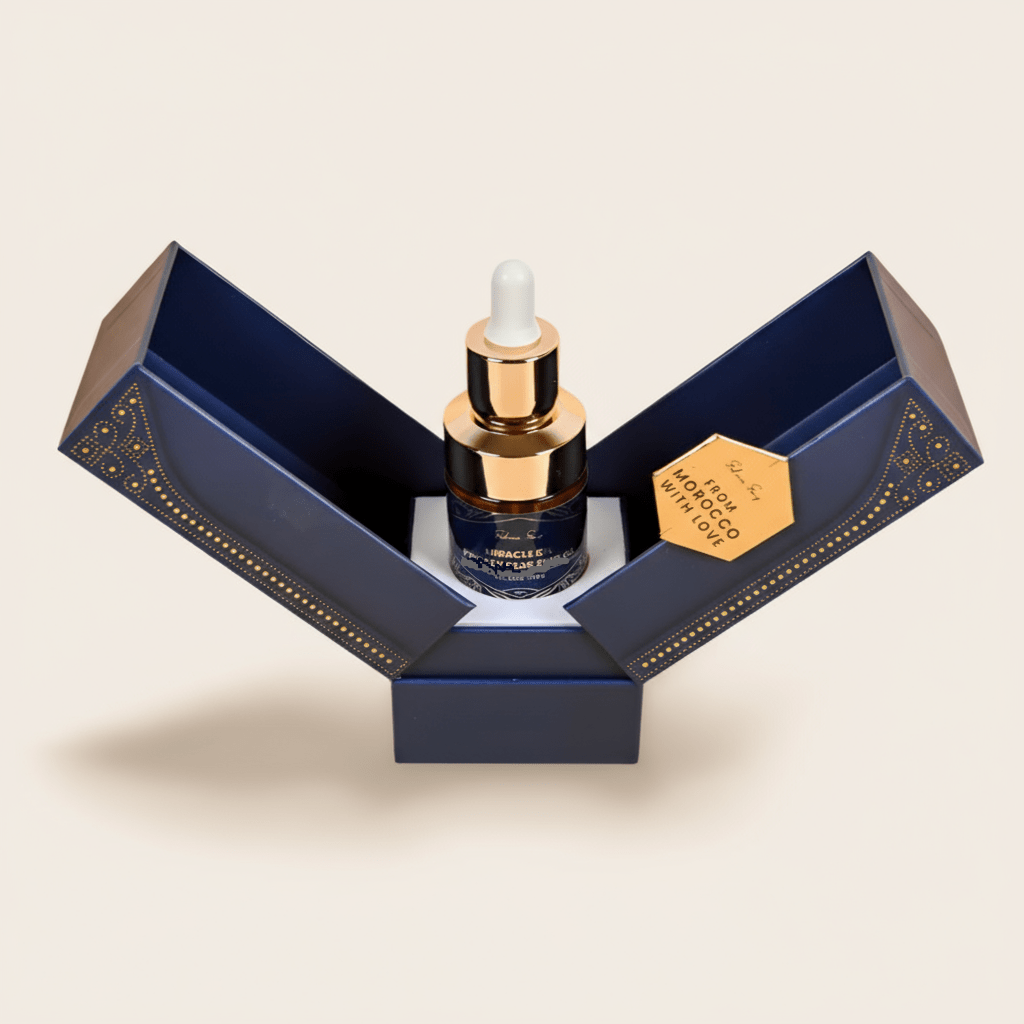 Pure argan oil dropper bottle in an open navy and gold gift box