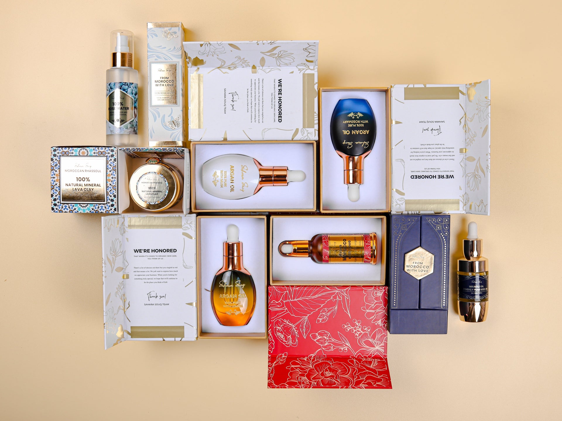 All Products upper shot for Saharasouq bottles and jars made for skin care on creamy plain background