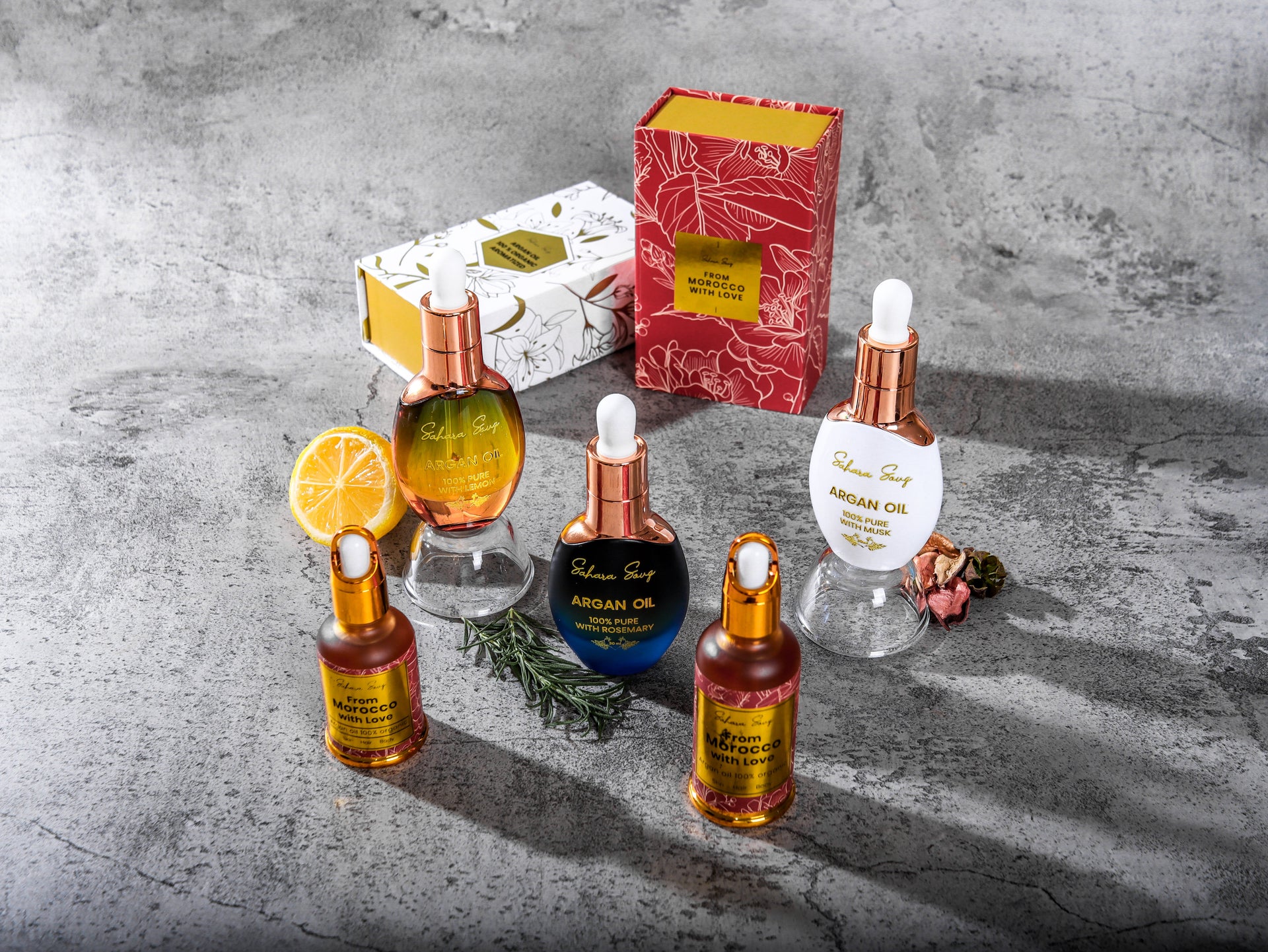 dropper bottles of argan oil  in different colors and luxury style on grey background