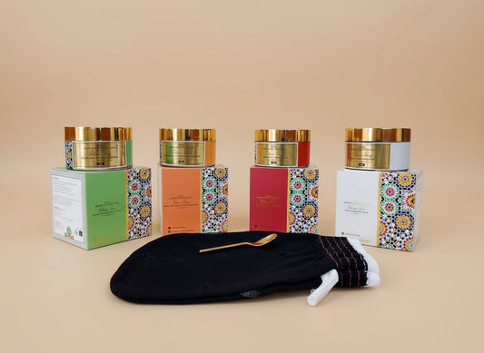 Cosmetic products with decorative boxes on a table in a store setting.