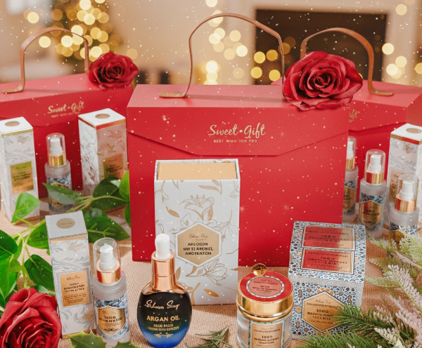 Cosmetic set with red gift box and decorative elements on a festive background